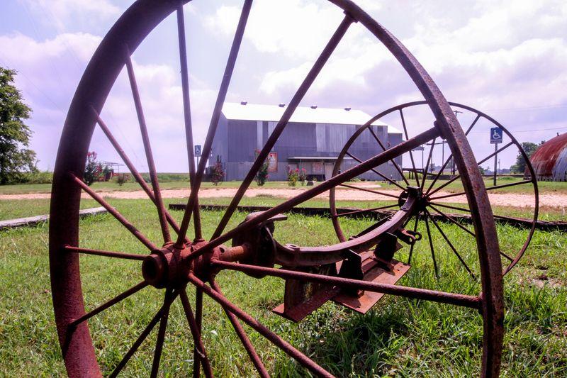 ETHIC Museum and Glendora Cotton Gin, seen through farming implement. 2015. The former Glendora Cotton Gin is seen in the distance. The building now houses the Emmett Till Historic Intrepid Center — the only museum in the world dedicated entirely to the Till murder.